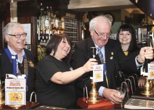 District Governor David McDowell pulls the first pint of the Lons Centenniel Ale