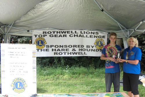 The "Top Gear Challenge" winner Daniel receives his prize from Lion President Jackie 